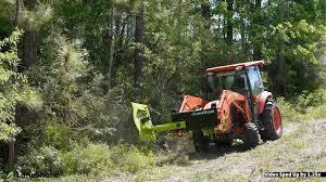 Lane Shark cutter clearing trail beside wooded area